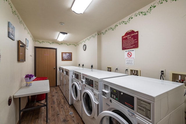 laundry room with washer and clothes dryer and dark hardwood / wood-style floors