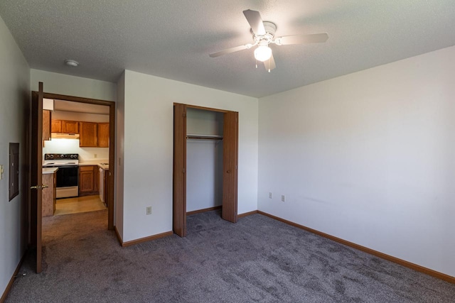 unfurnished bedroom featuring a textured ceiling, carpet, ceiling fan, and a closet