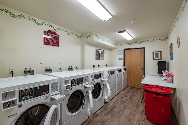 laundry area featuring dark hardwood / wood-style flooring and washing machine and dryer