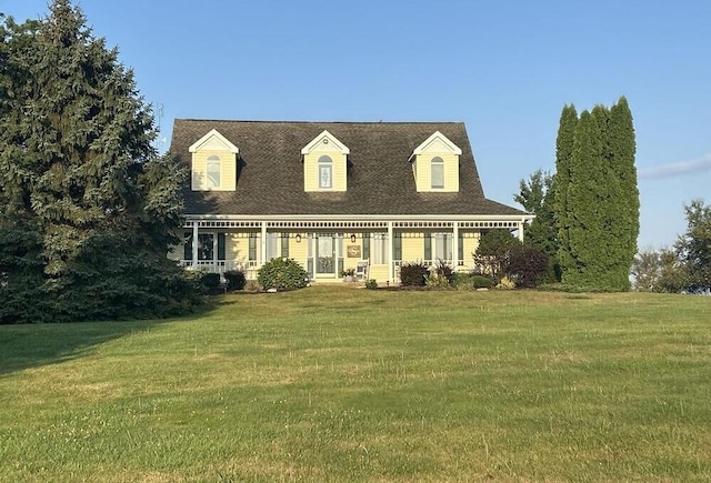 new england style home featuring a front lawn and a porch