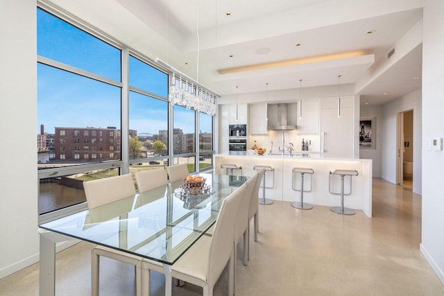 dining area featuring a raised ceiling