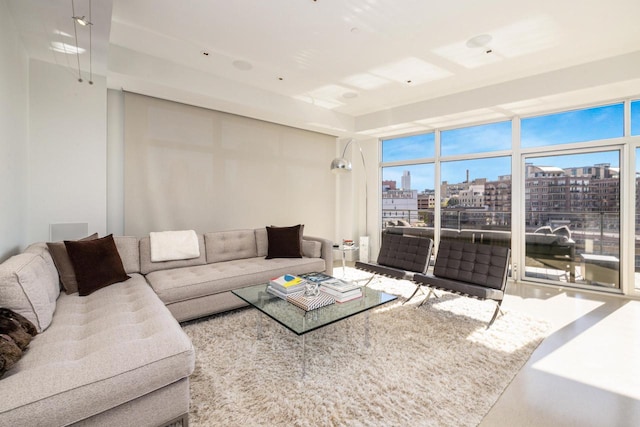 living room with floor to ceiling windows and a healthy amount of sunlight