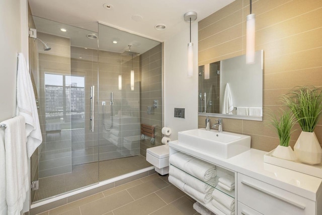 bathroom featuring walk in shower, vanity, and tile patterned flooring