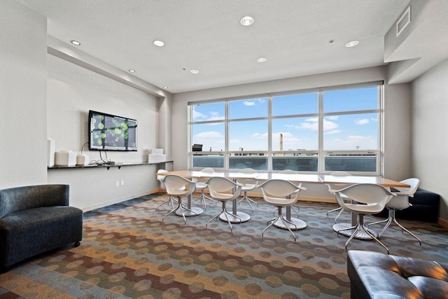 carpeted living room featuring a textured ceiling