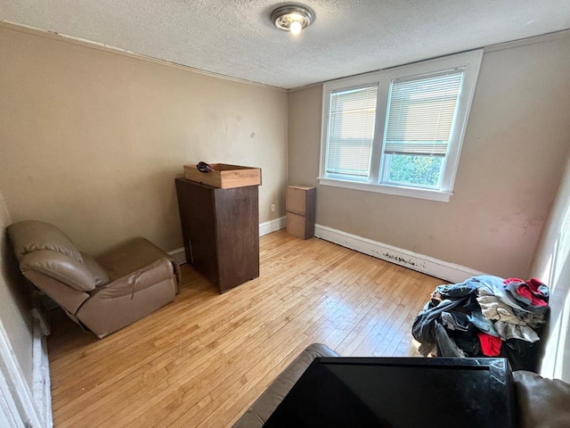 sitting room with light hardwood / wood-style floors and a textured ceiling