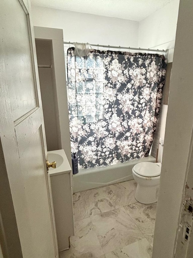 full bathroom featuring toilet, vanity, and shower / bath combination with curtain