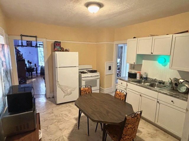 kitchen featuring white cabinets, a textured ceiling, sink, and white appliances