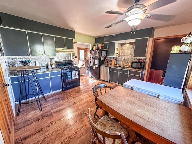 kitchen with tasteful backsplash, black appliances, ceiling fan, light hardwood / wood-style flooring, and sink