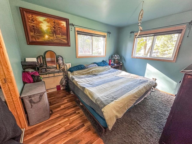 bedroom with dark wood-type flooring