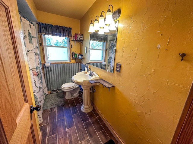 bathroom featuring wood-type flooring, sink, and toilet