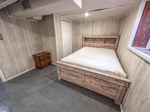 bedroom featuring a closet and wood walls