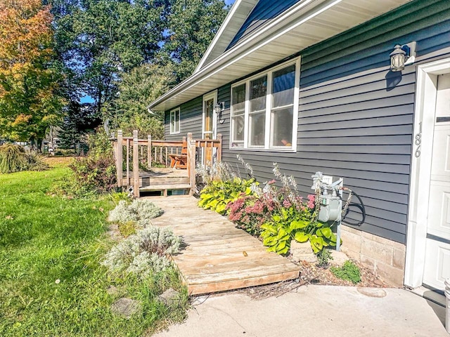 view of exterior entry featuring a wooden deck