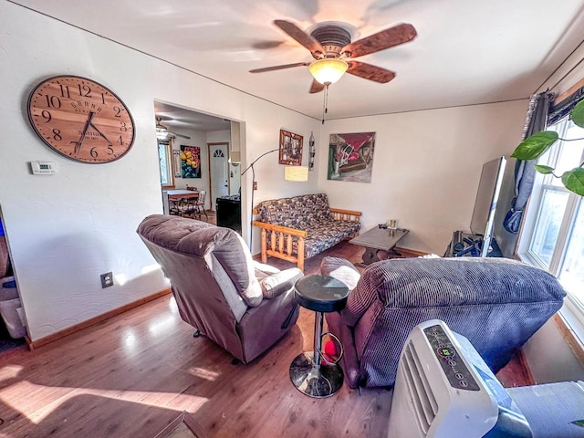 living room featuring wood-type flooring and ceiling fan