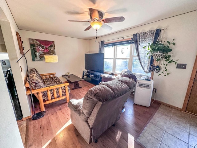 living room featuring ceiling fan and hardwood / wood-style flooring