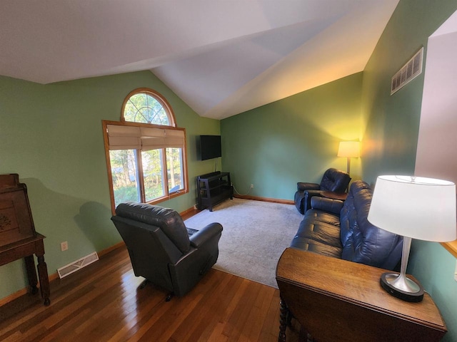 living room featuring lofted ceiling and dark wood-type flooring