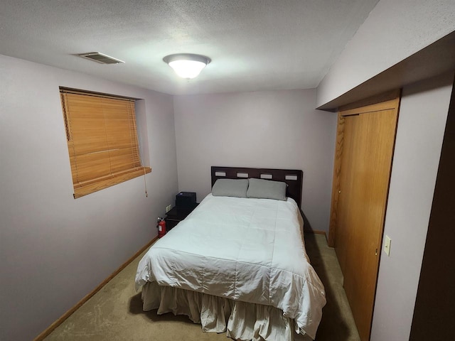 carpeted bedroom with a textured ceiling