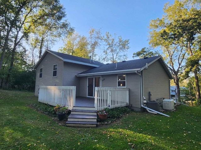 back of house featuring a deck and a yard