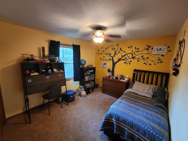 carpeted bedroom featuring ceiling fan and a textured ceiling