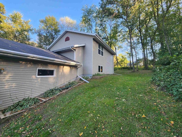 view of home's exterior with a yard