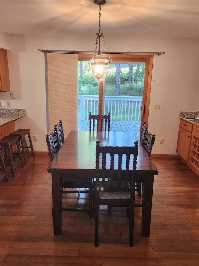 dining space with dark hardwood / wood-style flooring