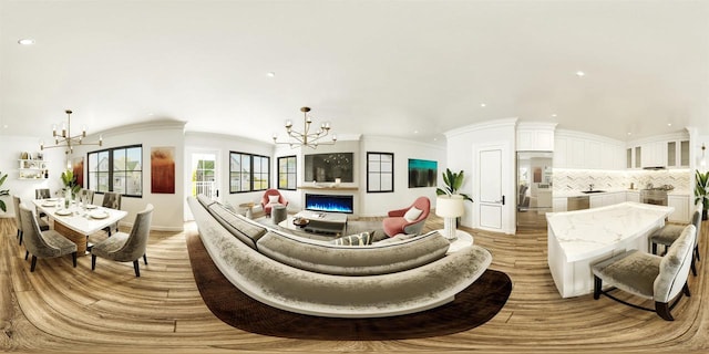 living room featuring ornamental molding and a notable chandelier