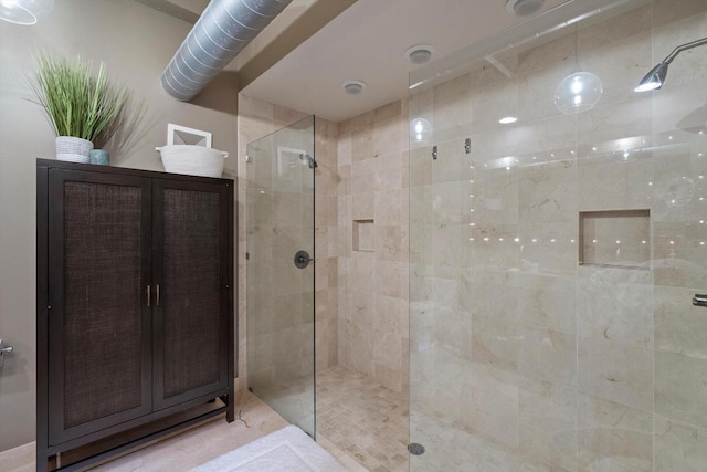 bathroom with a shower with door