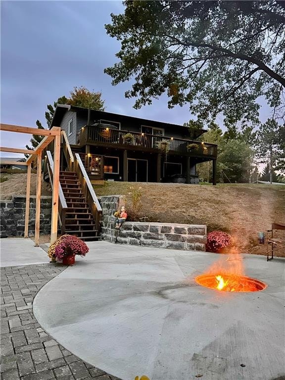 playground at dusk with a patio area and a deck