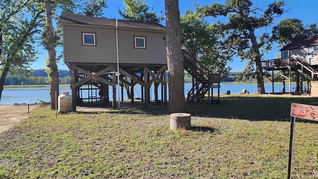 dock area with a lawn and a deck with water view