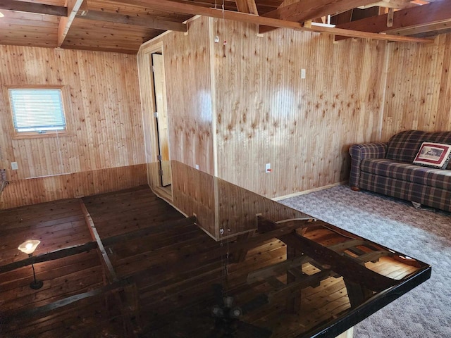 interior space with hardwood / wood-style floors and wooden walls