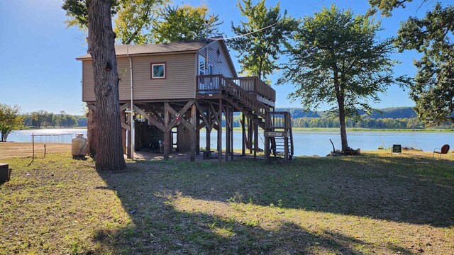 view of side of property with a deck with water view and stairway