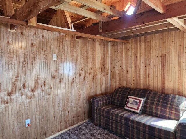 unfurnished room featuring carpet floors and wood walls