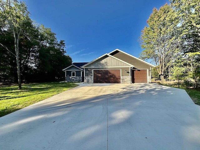 ranch-style home with a garage and a front lawn