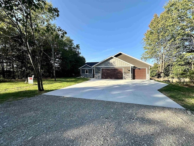 view of front of property with a garage and a front lawn