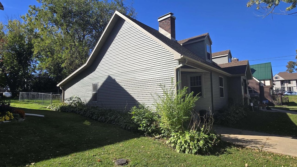 view of property exterior with a yard