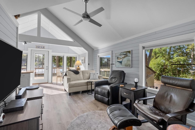 sunroom / solarium with ceiling fan, vaulted ceiling, and a wealth of natural light