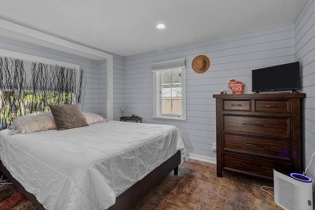 carpeted bedroom with wooden walls