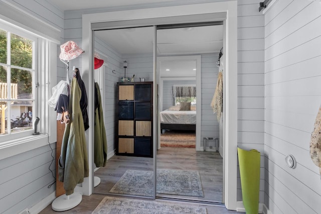 bathroom featuring wood walls and hardwood / wood-style floors