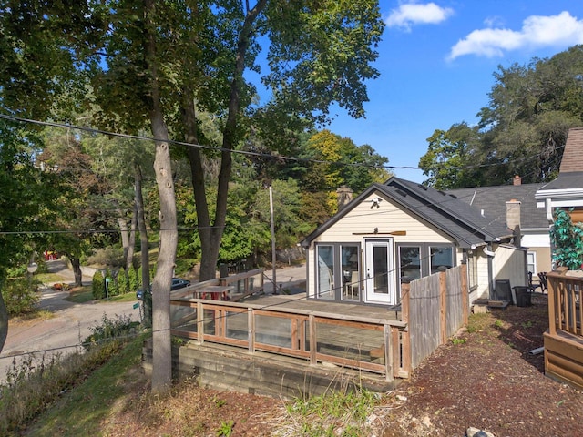 back of property with a wooden deck