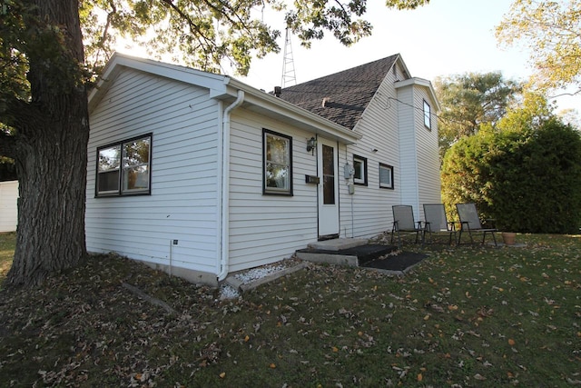 back of property featuring a lawn