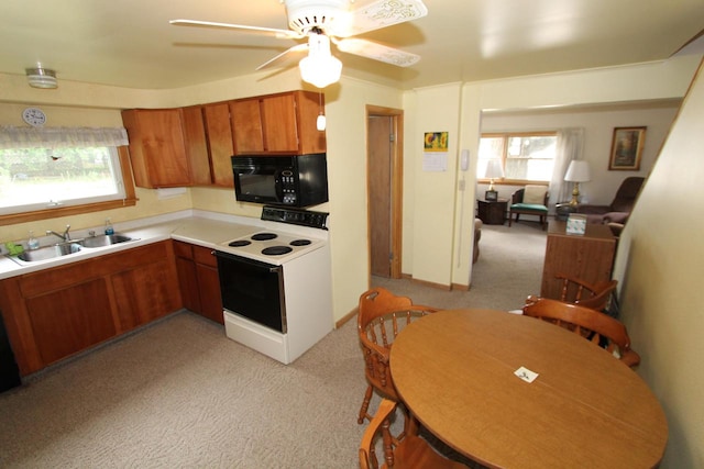 kitchen with light carpet, white range with electric cooktop, sink, and ceiling fan