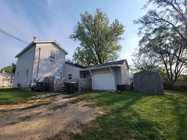 back of property featuring a yard, a storage unit, and a garage