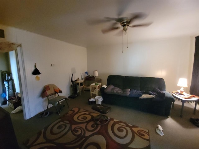 carpeted living room with ceiling fan