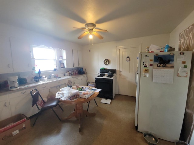 kitchen featuring ceiling fan, white appliances, and white cabinetry