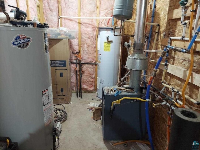 utility room featuring gas water heater and electric water heater