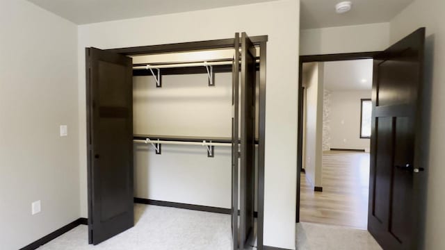 unfurnished bedroom featuring a closet and baseboards