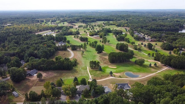 aerial view featuring golf course view and a forest view