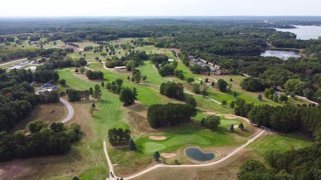 bird's eye view featuring a water view, a view of trees, and golf course view