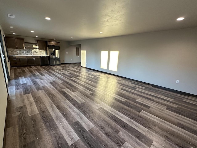 unfurnished living room featuring recessed lighting and dark wood finished floors