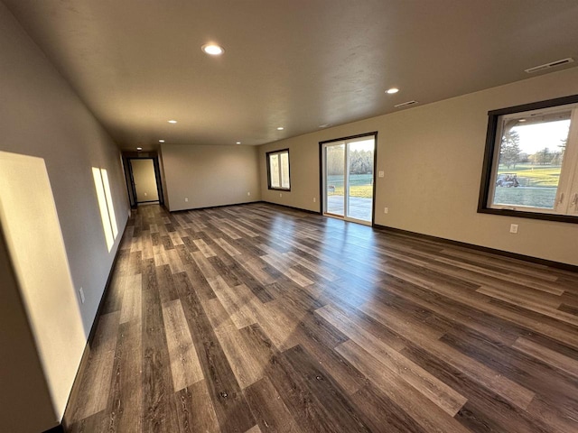 spare room with recessed lighting, visible vents, baseboards, and dark wood-style flooring