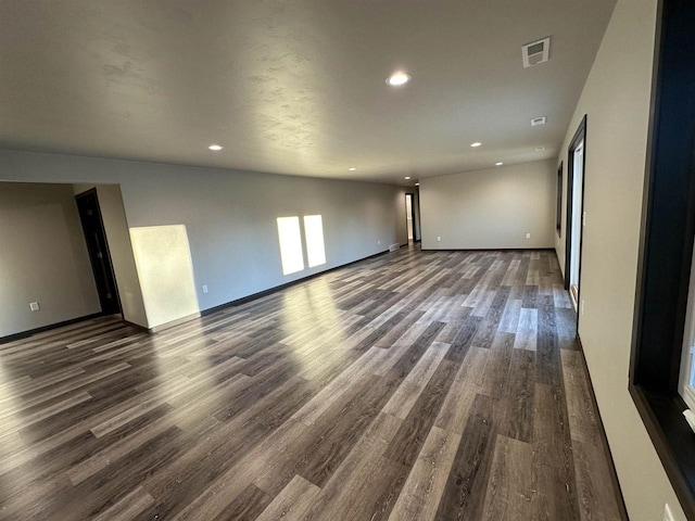 empty room with recessed lighting, visible vents, baseboards, and wood finished floors